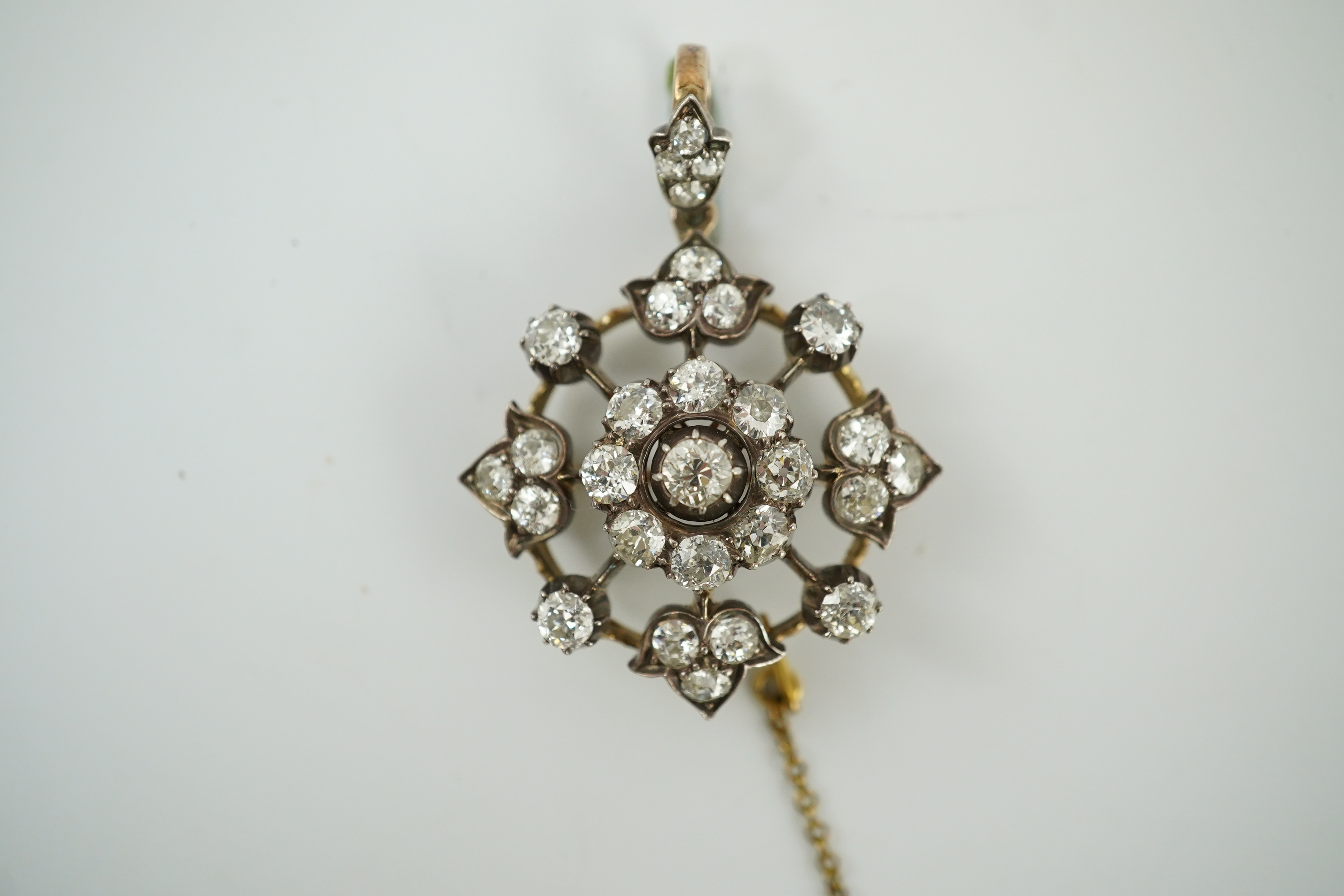 A late Victorian gold, silver and diamond cluster circular pendant brooch